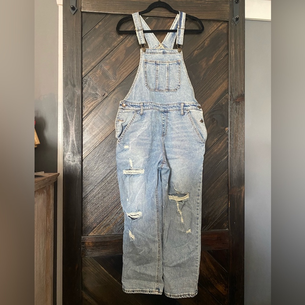 Size M light wash denim overalls.